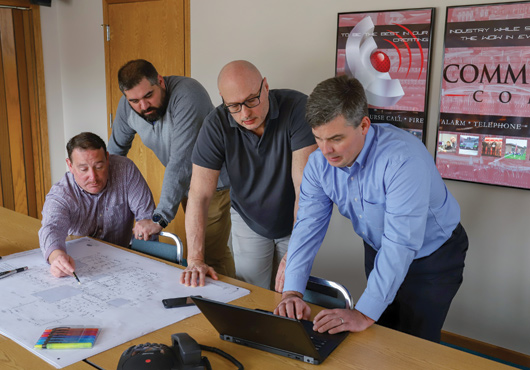 Team members looking over drawings. Left to right: Tony Closson, Sean Scott, Barry Combs and Mark Petras.